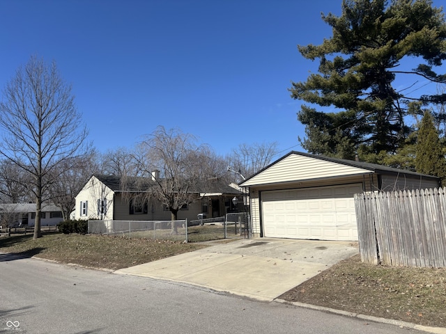 view of front of home with a garage, fence, and an outbuilding