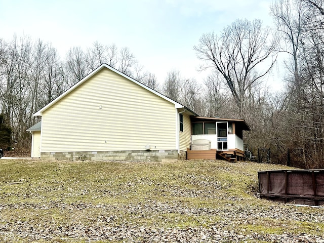 view of side of home with a sunroom