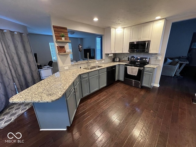 kitchen with black dishwasher, stainless steel electric range oven, tasteful backsplash, dark wood-type flooring, and a peninsula