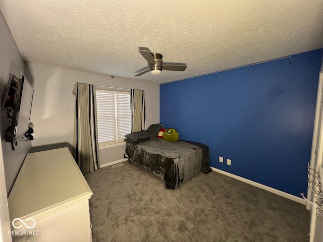 bedroom featuring ceiling fan, baseboards, dark colored carpet, and a textured ceiling