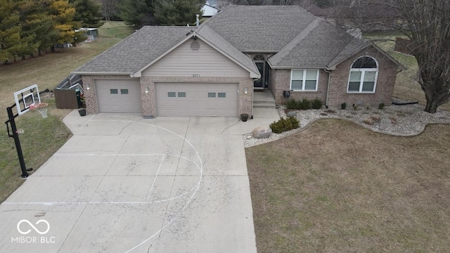 view of front facade featuring a garage, roof with shingles, concrete driveway, and brick siding