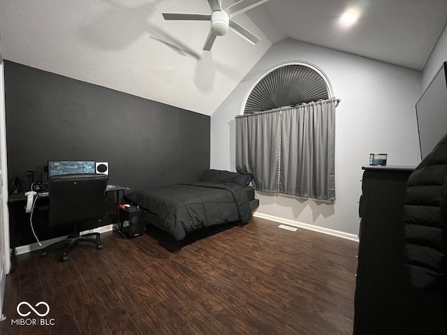 bedroom featuring dark wood-style floors, visible vents, vaulted ceiling, ceiling fan, and baseboards