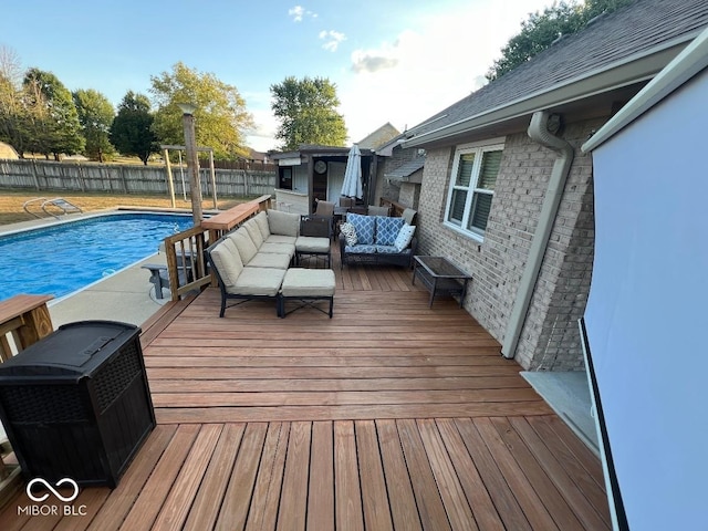 wooden deck featuring a fenced in pool, a fenced backyard, and outdoor lounge area