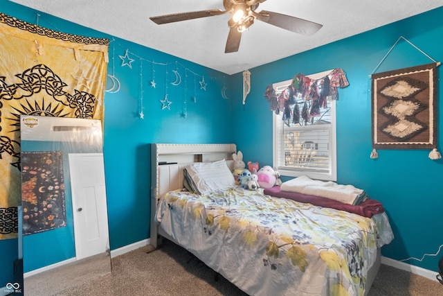 bedroom with a textured ceiling, carpet flooring, a ceiling fan, and baseboards