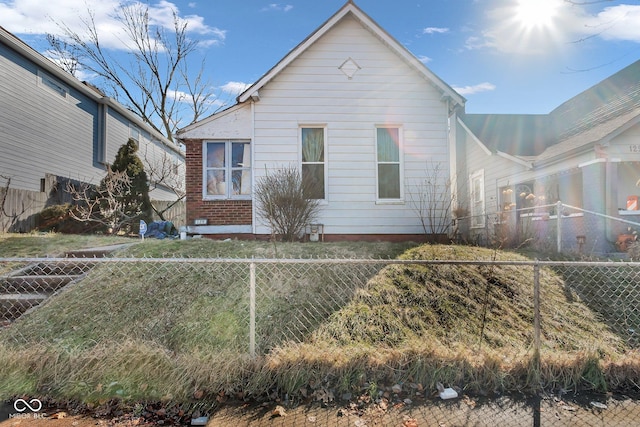 view of side of home featuring fence private yard and brick siding