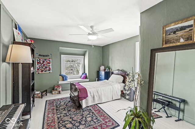 bedroom with wood finished floors and a ceiling fan