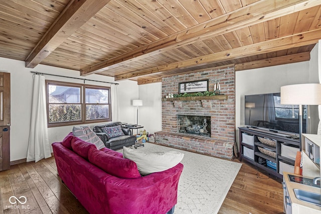 living room with wood ceiling, a brick fireplace, beamed ceiling, and wood-type flooring