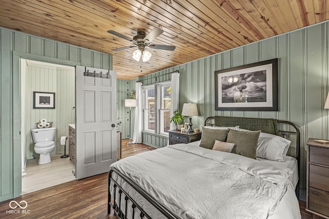 bedroom featuring ensuite bath, wood ceiling, and dark wood-type flooring