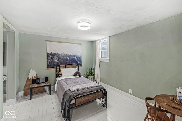 bedroom featuring light wood-type flooring and baseboards