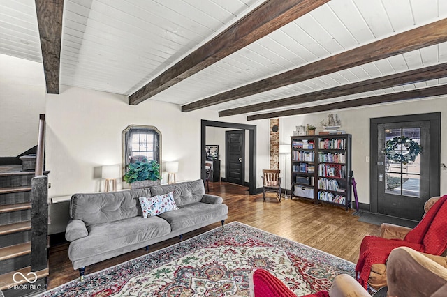 living area with baseboards, wooden ceiling, stairway, wood finished floors, and beam ceiling