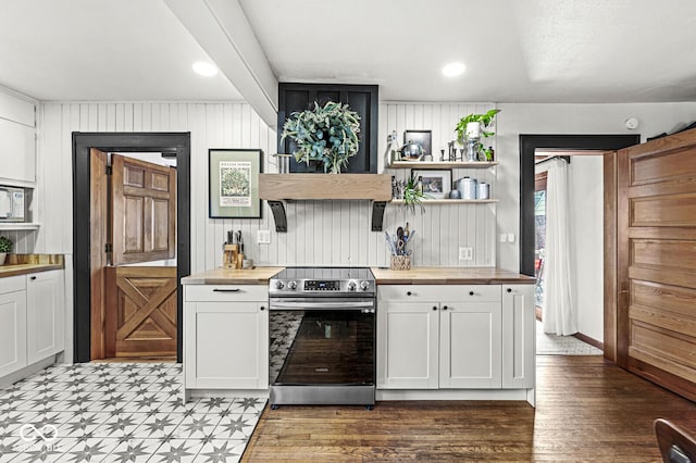 kitchen with white cabinets, wood counters, stainless steel electric range, and open shelves