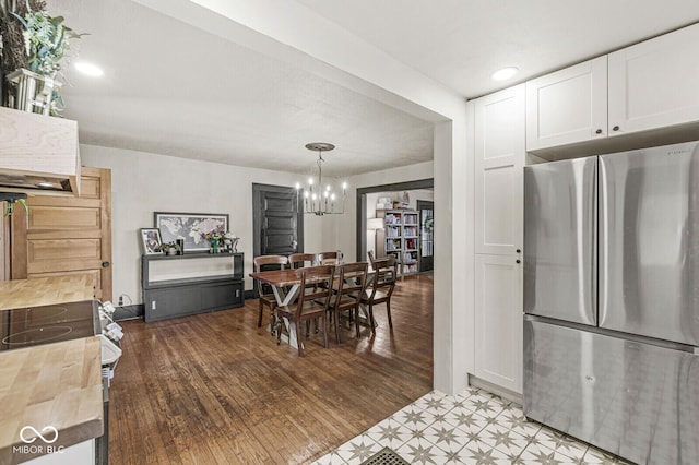 dining space featuring an inviting chandelier and wood finished floors