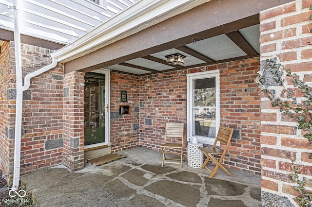 property entrance with brick siding