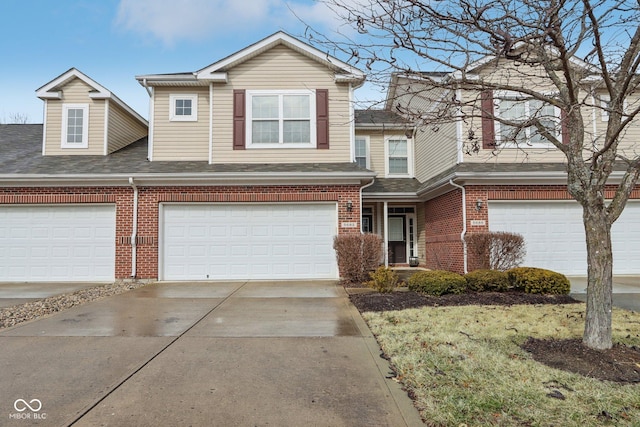 view of front of house featuring driveway, a shingled roof, a garage, and brick siding