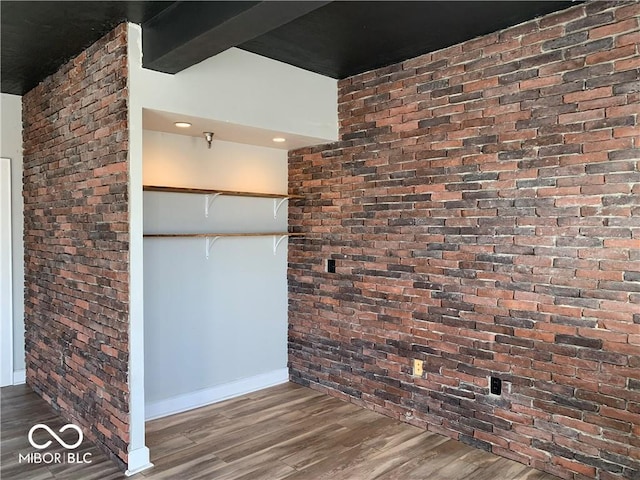 interior space with beamed ceiling, wood finished floors, and baseboards