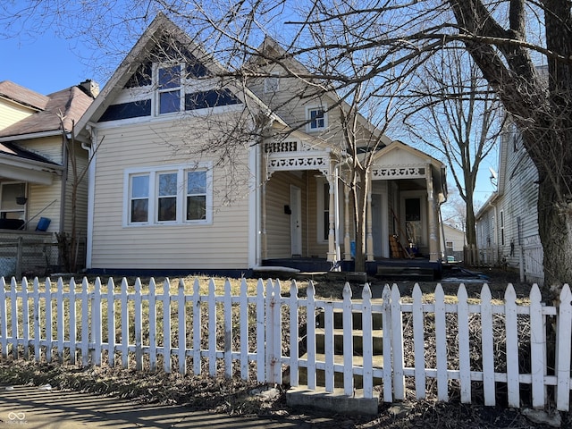 victorian-style house with a fenced front yard