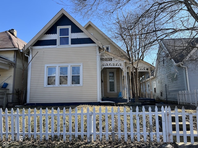 victorian home with a fenced front yard