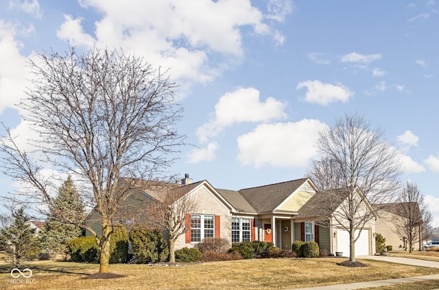 ranch-style home with a garage, a front yard, concrete driveway, and a chimney