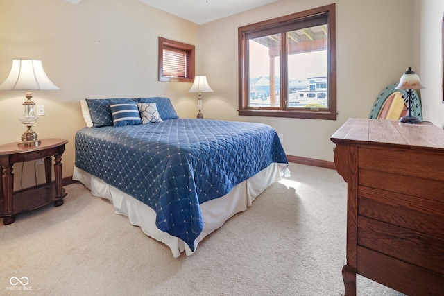 carpeted bedroom featuring baseboards