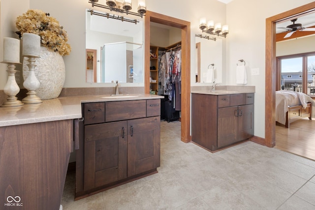 full bath with ensuite bathroom, two vanities, and a sink