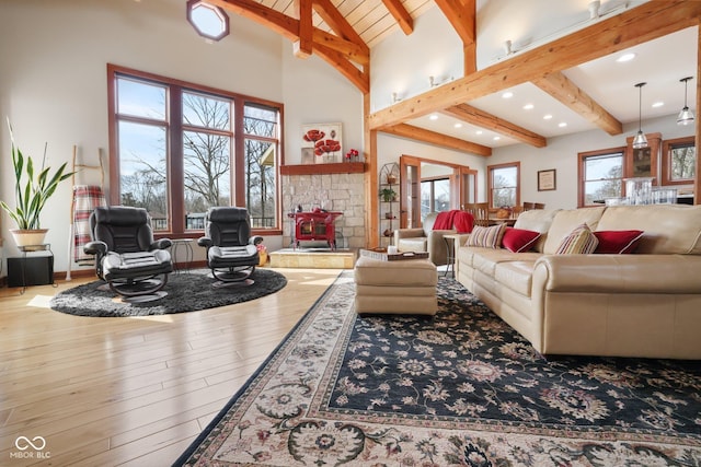 living room featuring high vaulted ceiling, wood finished floors, beam ceiling, and recessed lighting