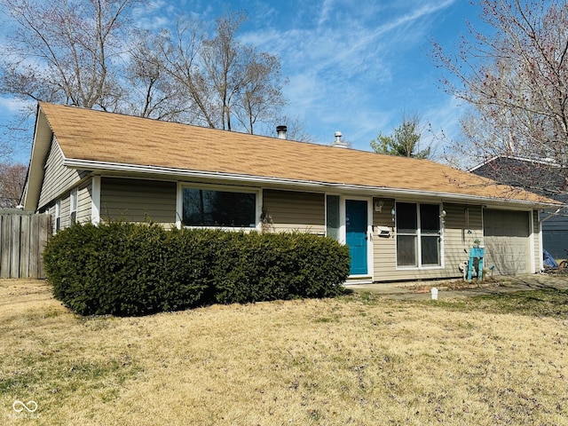 ranch-style house featuring a garage and a front lawn