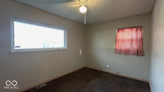 spare room with visible vents, baseboards, carpet, a textured ceiling, and a ceiling fan