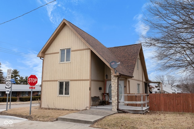 view of front of house with fence and roof with shingles