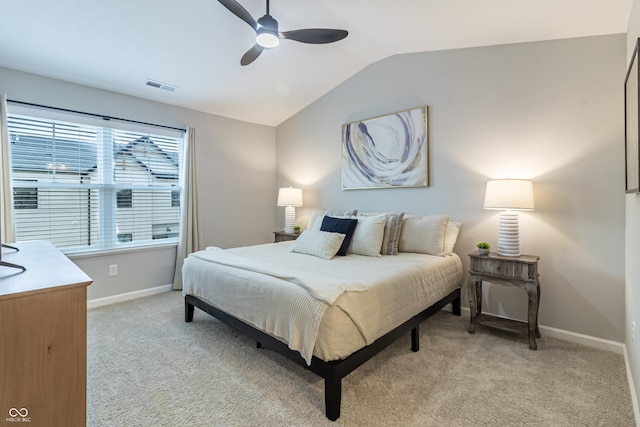 bedroom with light carpet, lofted ceiling, visible vents, and baseboards