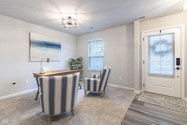 office with visible vents, a textured ceiling, and baseboards