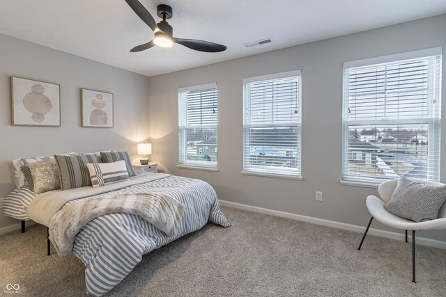 bedroom featuring baseboards, visible vents, ceiling fan, and carpet flooring