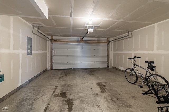 garage with a garage door opener and electric panel