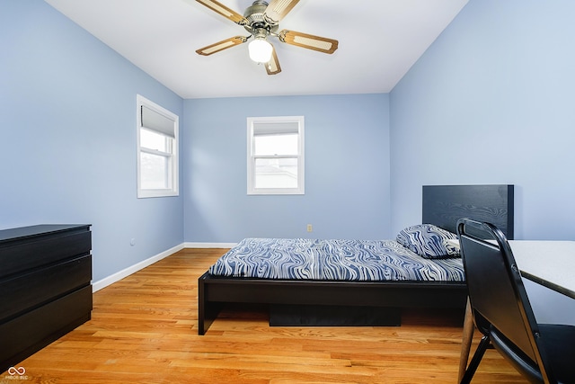 bedroom featuring light wood-style floors, ceiling fan, and baseboards