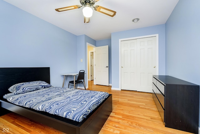 bedroom with a ceiling fan, light wood-type flooring, a closet, and baseboards