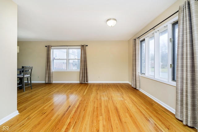 unfurnished room featuring light wood-style flooring and baseboards