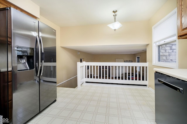 kitchen with dishwashing machine, stainless steel fridge, light countertops, and baseboards