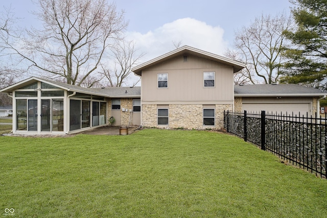 rear view of property with a garage, a sunroom, a fenced backyard, and a lawn