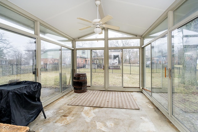 sunroom with ceiling fan and vaulted ceiling