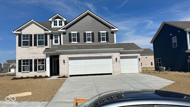 traditional-style home with brick siding, central AC, driveway, and a shingled roof