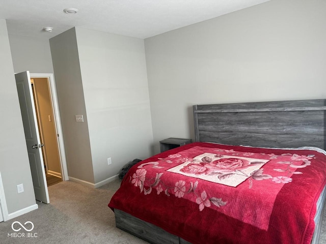 carpeted bedroom featuring baseboards