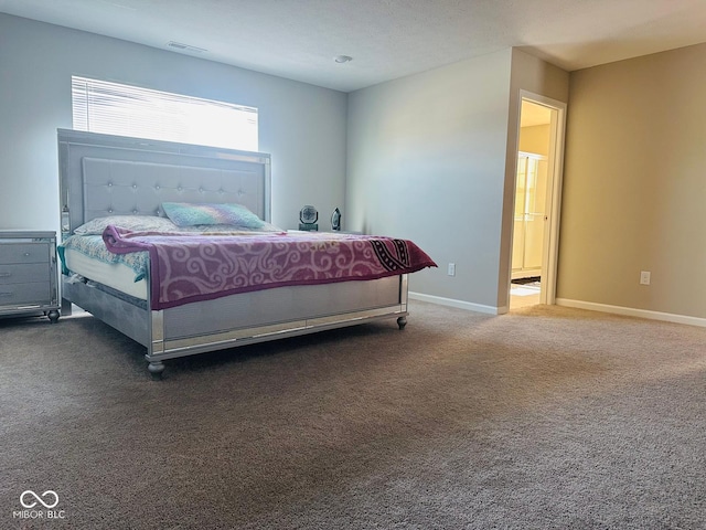 carpeted bedroom with visible vents and baseboards