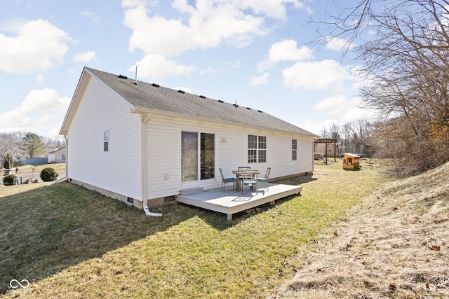 back of house featuring crawl space, a shingled roof, a deck, and a yard