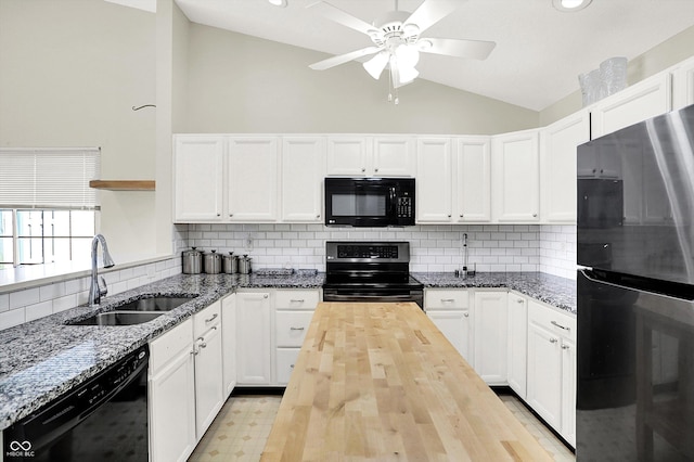 kitchen featuring black appliances, butcher block counters, a sink, and white cabinetry