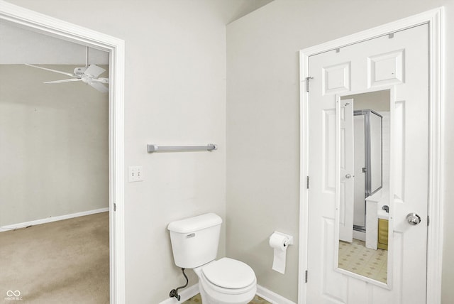 bathroom with toilet, baseboards, and a ceiling fan