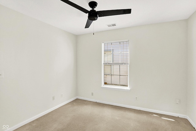 unfurnished room featuring ceiling fan, carpet, visible vents, and baseboards