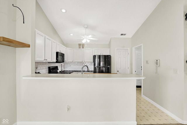 kitchen featuring a peninsula, a ceiling fan, baseboards, backsplash, and black appliances