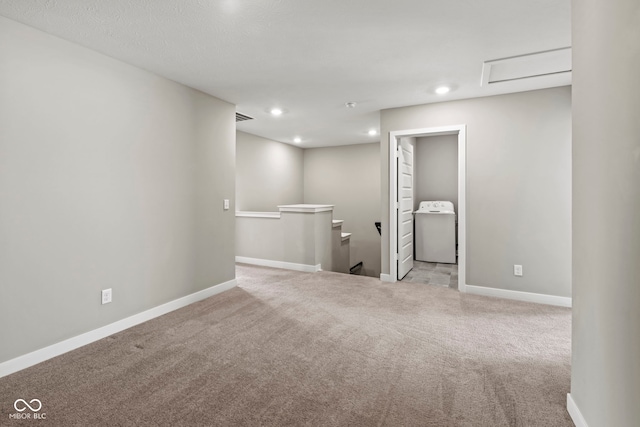 empty room featuring carpet floors, washer / dryer, baseboards, and recessed lighting