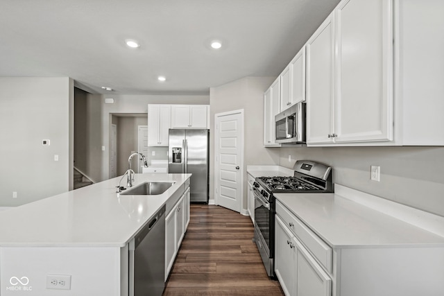 kitchen with white cabinets, dark wood-style flooring, stainless steel appliances, a sink, and recessed lighting