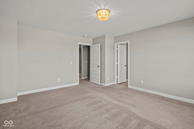 unfurnished bedroom featuring carpet flooring and baseboards