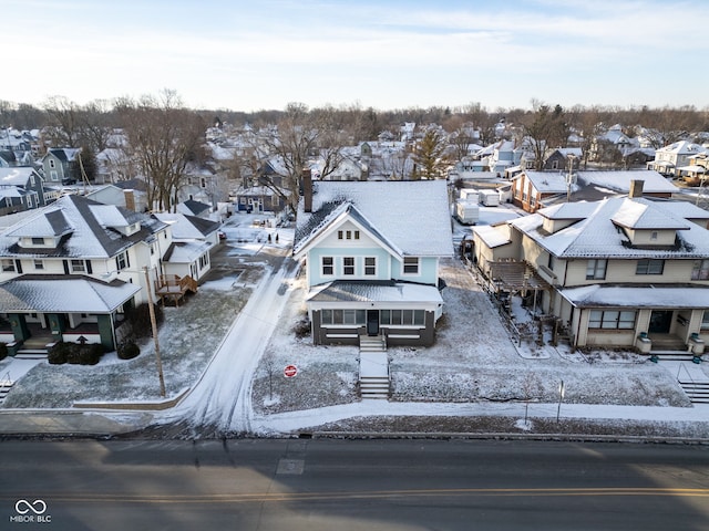 snowy aerial view featuring a residential view